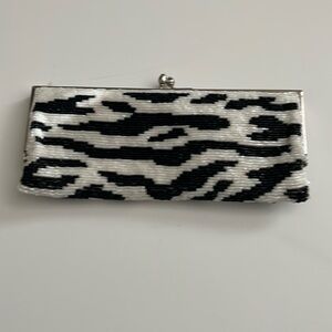 Vintage black and white beaded clutch with strap.
